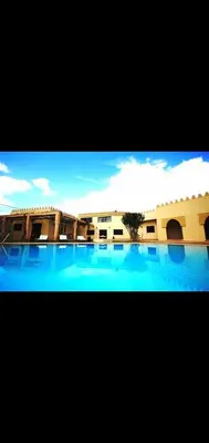 a view of a building with a large swimming pool at Villa athis in Fourou