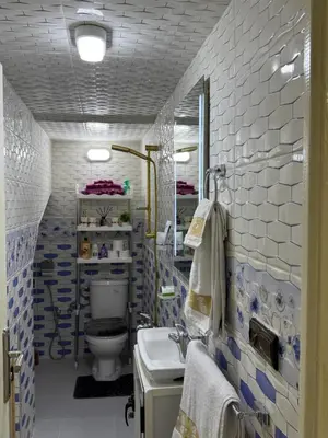 a bathroom with a toilet and a sink at Appartement élégant à Meknès in Meknès