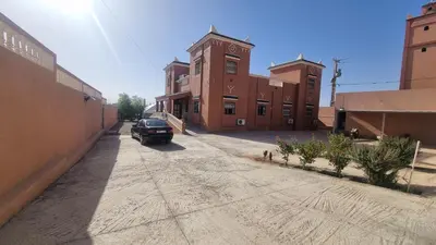 a car parked on a dirt road in front of a building at Villa kaddi in Tinerhir