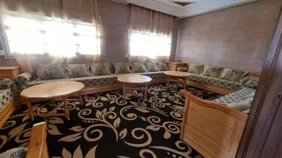 a living room with a couch and a table and chairs at Villa kaddi in Tinerhir