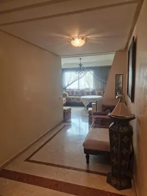 a living room with a couch and a chair at Ilar Appartement in Oulad Akkou