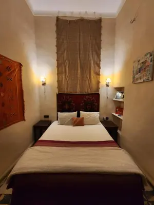 a bedroom with a large bed with a window at Dar Lala Chafia Fes in Fès
