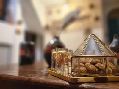 a glass container of cookies on a table at Dar Lala Chafia Fes in Fès