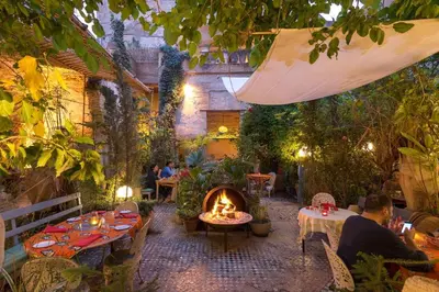 a patio with a fire pit in a garden at Dar Lala Chafia Fes in Fès