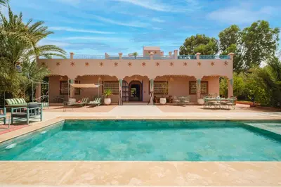 a house with a swimming pool in front of it at Dar Salah - Eddine Oasis Pool & SPA in Marrakech
