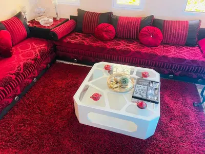 a living room with a couch and a table at Appartement luxe 2 Chambres 5 min du Centre Ville in Fès