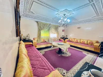 a living room with a couch and a table at Appartement luxe 2 Chambres 5 min du Centre Ville in Fès
