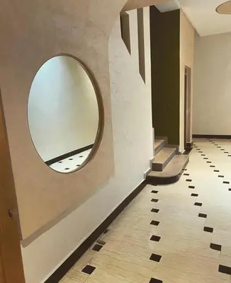a hallway with a round mirror on the wall at Appartement lux résidence fermée sécurisé parking gratuit in Fès