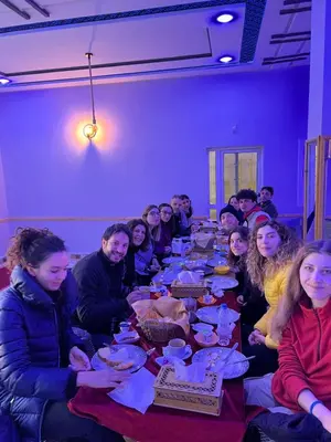 a group of people sitting at a long table with food at Kasbah Dounia in Kerrando
