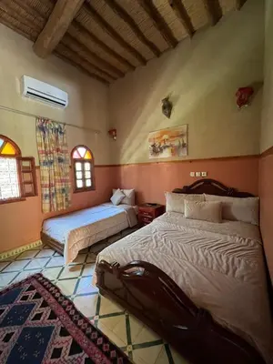 a bedroom with two beds in a room at Kasbah Dounia in Kerrando