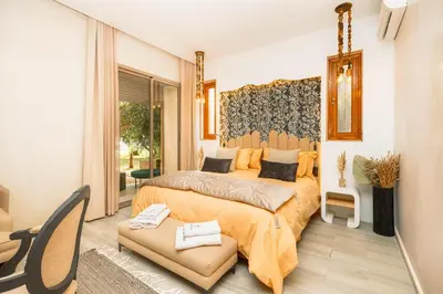 a bedroom with a king sized bed and a window at Villa Stevana in Oulad Mazoug