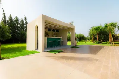 a pavilion with a kitchen in a park at Villa Stevana in Oulad Mazoug