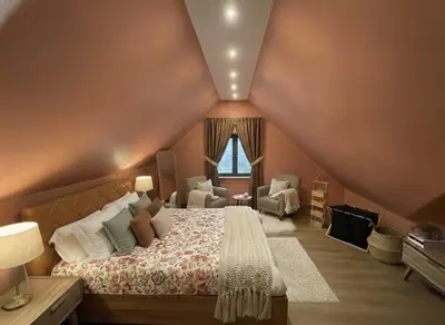 a bedroom with a bed and a chair and a window at Villa Lumiere-Luxury Retreat with Private Spa and Garden in Ifrane