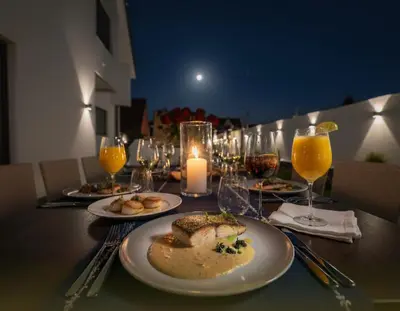 a table with plates of food and glasses of wine at Villa Lumiere-Luxury Retreat with Private Spa and Garden in Ifrane