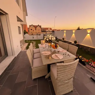 a patio with a table and chairs on a balcony at Villa Lumiere-Luxury Retreat with Private Spa and Garden in Ifrane