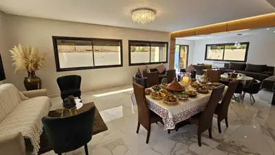a dining room with a table and chairs at Villa Lumiere-Luxury Retreat with Private Spa and Garden in Ifrane