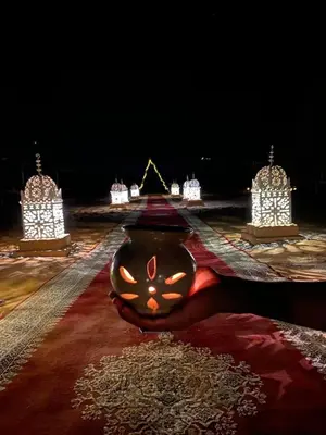 a person laying on a rug with aookyooky at Desert Marhaba luxury Camp in Merzouga