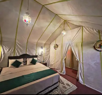 a bedroom with a bed in a tent at Desert Marhaba luxury Camp in Merzouga