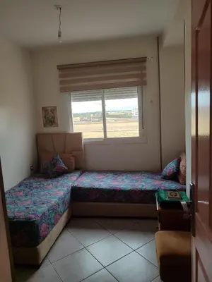 a small bedroom with a bed and a window at Appart prés du chu fes fes shore in Fès