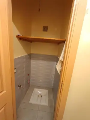a small bathroom with a toilet in the floor at Appart prés du chu fes fes shore in Fès