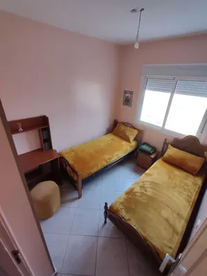 a small room with two beds and a window at Appart prés du chu fes fes shore in Fès