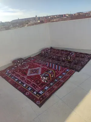 two rugs on the floor on top of a wall at Relaxnstay midelt in Midelt
