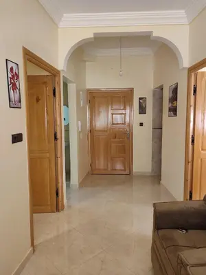 a living room with a couch and a wooden door at Relaxnstay midelt in Midelt