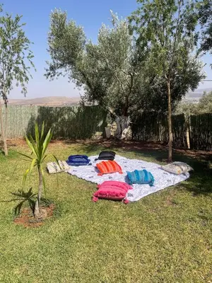 a group of towels laying on a blanket on the grass at Ferme Erraha in Bhalil