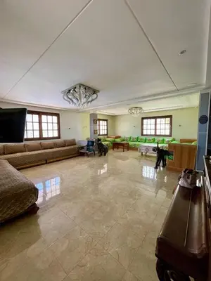 a large living room with couches and dogs in it at Ferme Erraha in Bhalil