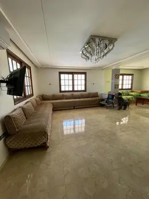 a large living room with couches and a flat screen tv at Ferme Erraha in Bhalil