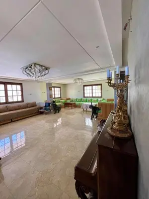 a large living room with a couch and a table at Ferme Erraha in Bhalil