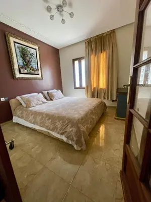 a bedroom with a bed and a window at Ferme Erraha in Bhalil