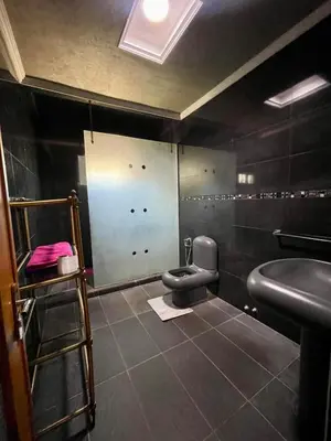 a bathroom with a toilet and a sink at Ferme Erraha in Bhalil