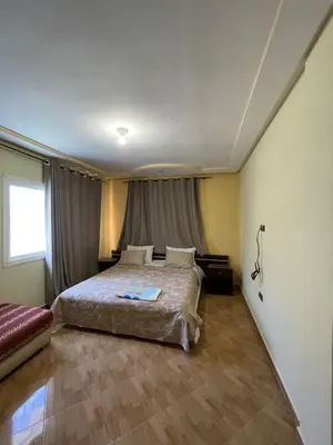 a bedroom with a large bed in a room at Ferme Erraha in Bhalil