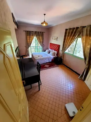 a bedroom with a bed and a desk in it at Marrakech LUXE in Oulad Akkou