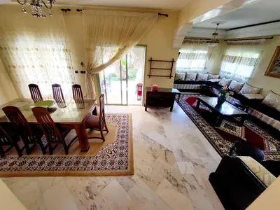 a living room with a table and a couch at Marrakech LUXE in Oulad Akkou