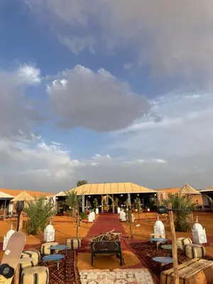 aented area with tables and chairs in the desert at Merzouga in Merdani