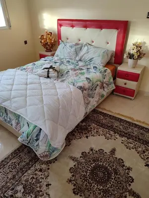 a bedroom with a large bed and a rug at Relaxnstay in Midelt