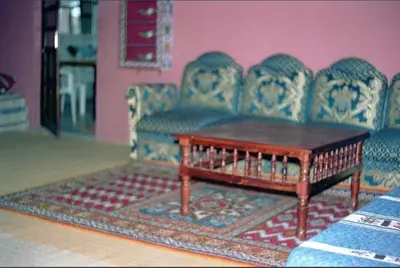 a living room with a couch and a coffee table at le sirwa salam in Anzel