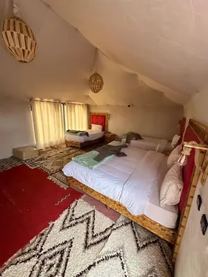 a bedroom with a large bed in a attic at Fabulous Luxury Camp in Merzouga