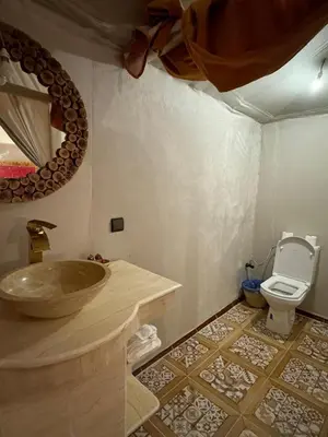 a bathroom with a sink and a toilet at Fabulous Luxury Camp in Merzouga