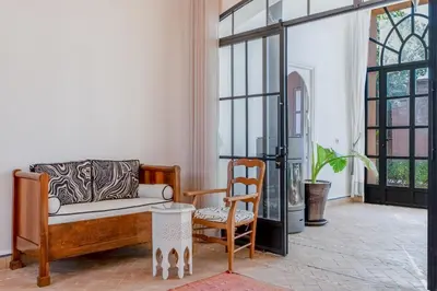 a living room with a couch and a chair at Villa Cannella - Marrakech in Chaibate