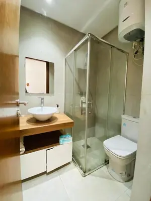 a bathroom with a shower and a sink and a toilet at Modern studio, ideal location in Oulad Akkou