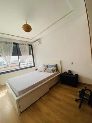 a bedroom with a large bed and a window at Modern studio, ideal location in Oulad Akkou