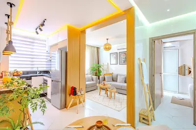 a living room with a couch and a kitchen at Grand Appartement avec Balcon Marrakech in Oulad Akkou