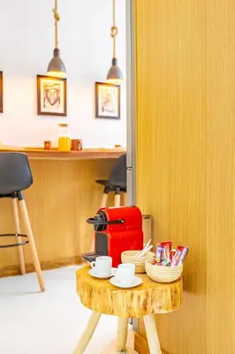 a coffee table with a red suitcase on top of it at Grand Appartement avec Balcon Marrakech in Oulad Akkou