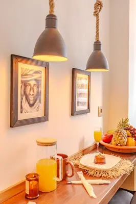 a table with orange juice and a plate of fruit at Grand Appartement avec Balcon Marrakech in Oulad Akkou