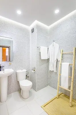 a bathroom with a toilet and a sink at Grand Appartement avec Balcon Marrakech in Oulad Akkou
