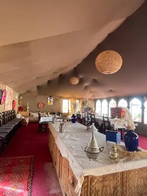a large room with a long table in a building at Luxury Desertcamp in Merdani