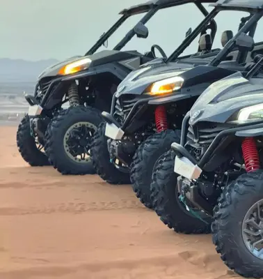a row of four atvs parked in the sand at Desertwhispercamp in Merzouga